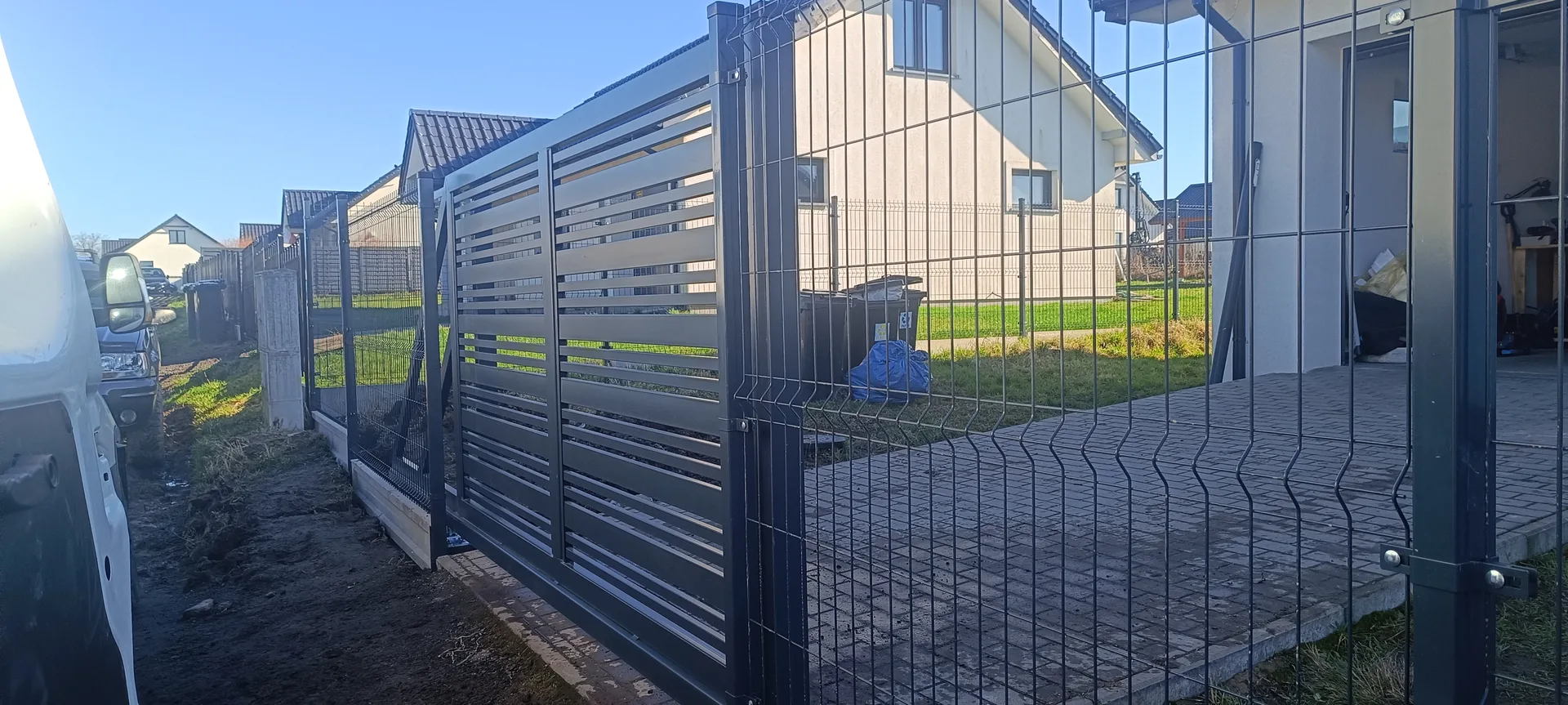 Dom z nowoczesnym ogrodzeniem metalowym